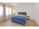 Bright bedroom with light wood floors, large windows, and a blue comforter at 2928 Cape Verde Ln, Las Vegas, NV 89128