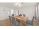 Bright dining room features a large wooden table with gray chairs and a stylish light fixture at 2928 Cape Verde Ln, Las Vegas, NV 89128
