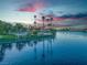 Scenic lakefront property at sunset with palm trees at 2928 Cape Verde Ln, Las Vegas, NV 89128