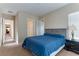 Spacious bedroom with a queen-size bed and access to a hallway at 37 Carolina Cherry Dr, Las Vegas, NV 89141