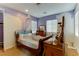 Charming bedroom with wooden sleigh bed and decorative accents at 37 Carolina Cherry Dr, Las Vegas, NV 89141