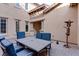 Outdoor patio area with table and chairs, string lights, and metal sculpture at 37 Carolina Cherry Dr, Las Vegas, NV 89141