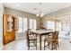 Bright dining room with a wooden table and chairs, and access to backyard at 37 Carolina Cherry Dr, Las Vegas, NV 89141
