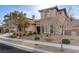 Two-story house with stone and stucco exterior, brown garage doors, and landscaped yard at 37 Carolina Cherry Dr, Las Vegas, NV 89141
