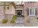 Ornate iron gate entrance to a two-story house with stone exterior at 37 Carolina Cherry Dr, Las Vegas, NV 89141