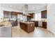 Modern kitchen with dark wood cabinetry, granite countertops, and stainless steel appliances at 37 Carolina Cherry Dr, Las Vegas, NV 89141