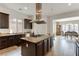 Modern kitchen with dark wood cabinetry, granite countertops, and stainless steel appliances at 37 Carolina Cherry Dr, Las Vegas, NV 89141