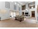 High ceiling living room with a large sectional sofa, a large wood table and access to a back patio at 37 Carolina Cherry Dr, Las Vegas, NV 89141