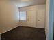 Spacious bedroom with dark carpet and neutral walls at 3833 Soda Springs Dr, Las Vegas, NV 89115