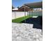 Covered patio and artificial turf backyard with gray patio at 4004 Adelphi Ave, Las Vegas, NV 89120