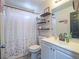 Modern bathroom features a sleek vanity with dual sinks, a mirror, and decorative shelves at 4004 Adelphi Ave, Las Vegas, NV 89120