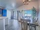 Bright dining room features a modern chandelier, tiled floors, and natural light from the sliding glass doors at 4004 Adelphi Ave, Las Vegas, NV 89120