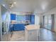 Bright kitchen with blue cabinets, stainless steel appliances, and an island featuring an eat in bar at 4004 Adelphi Ave, Las Vegas, NV 89120