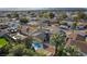 Aerial view of a charming home with a pool surrounded by mature trees and lush landscaping in a friendly neighborhood at 4110 Oakhill Ave, Las Vegas, NV 89121
