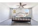 Bright bedroom with neutral walls, carpet flooring, ceiling fan, and natural light from two windows at 4110 Oakhill Ave, Las Vegas, NV 89121