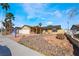 Single-story house with a covered porch, a two-car garage, and desert landscaping at 4110 Oakhill Ave, Las Vegas, NV 89121