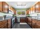 Bright kitchen featuring stainless steel appliances, wood cabinets, and granite countertops at 4110 Oakhill Ave, Las Vegas, NV 89121