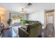 Well-lit living room with dark floors, large window view, and comfortable sofas at 4110 Oakhill Ave, Las Vegas, NV 89121