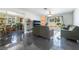 Open-concept living room featuring sleek flooring and glass sliding doors to the backyard at 4110 Oakhill Ave, Las Vegas, NV 89121