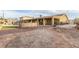 Spacious backyard with a partially landscaped yard and outdoor stone firepit at 4410 E Boston Ave, Las Vegas, NV 89104