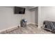 Basement area with gray flooring, a television, a storage system, and a gray crib at 4410 E Boston Ave, Las Vegas, NV 89104