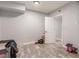 Basement area featuring gray flooring, a white door, a gray crib, and modern lighting at 4410 E Boston Ave, Las Vegas, NV 89104