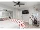 Bright bedroom features reflected mirrored closet doors, with a vanity and TV at 4410 E Boston Ave, Las Vegas, NV 89104