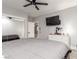 Bedroom with a ceiling fan, closet with mirrored doors, and mounted TV over a white dresser at 4410 E Boston Ave, Las Vegas, NV 89104