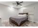 Bedroom with gray flooring, a ceiling fan, and a dark wood bed frame with drawer storage at 4410 E Boston Ave, Las Vegas, NV 89104