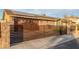 Beautiful home showcasing a gated driveway, a two-car garage, and solar panels for energy efficiency at 4410 E Boston Ave, Las Vegas, NV 89104