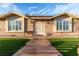 Inviting front entrance with manicured lawn, decorative stone steps, and well-maintained landscaping at 4410 E Boston Ave, Las Vegas, NV 89104