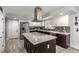 Modern kitchen with stainless steel appliances and a large island cooktop at 4410 E Boston Ave, Las Vegas, NV 89104