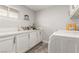 Well-organized laundry room with modern cabinetry, marble flooring, and ample counter space at 4410 E Boston Ave, Las Vegas, NV 89104