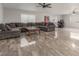 Spacious living room with a large sectional couch, ceiling fan, and large format marble flooring at 4410 E Boston Ave, Las Vegas, NV 89104