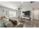 Comfortable living room features tile flooring, large windows with plantation shutters, and a ceiling fan at 4410 E Boston Ave, Las Vegas, NV 89104