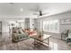Open-concept living area with tile floors, comfortable seating, and natural light from large windows at 4410 E Boston Ave, Las Vegas, NV 89104