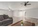 Bright and airy living room with a large format marble flooring and two ceiling fans at 4410 E Boston Ave, Las Vegas, NV 89104