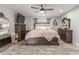 Comfortable main bedroom features wood-look floors, ceiling fan and updated furniture at 4410 E Boston Ave, Las Vegas, NV 89104