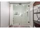 Modern bathroom shower with glass door, rainfall shower head, and white tile at 4410 E Boston Ave, Las Vegas, NV 89104