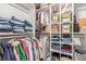 Spacious walk-in closet with shelves and hanging rods for organized storage at 4410 E Boston Ave, Las Vegas, NV 89104