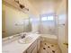 Bathroom with bathtub, single sink vanity, and tiled floor at 4684 Trevins Ave, Las Vegas, NV 89103