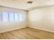 Bright bedroom with wood-look floors and window shutters at 4684 Trevins Ave, Las Vegas, NV 89103