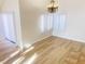 Bright dining room with chandelier and wood-look floors at 4684 Trevins Ave, Las Vegas, NV 89103