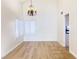 Formal dining area with hardwood floors, chandelier, and large windows at 4684 Trevins Ave, Las Vegas, NV 89103