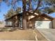 Two-story house with attached garage and mature tree in front yard at 4684 Trevins Ave, Las Vegas, NV 89103