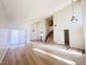 High-ceilinged living room with hardwood floors and view to kitchen at 4684 Trevins Ave, Las Vegas, NV 89103
