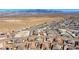 An aerial view of a neighborhood of single Gathering homes with desert landscape and mountain views in background at 4801 Westmont Dr, Pahrump, NV 89061