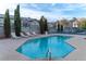 Community pool with lounge chairs and fencing at 5261 Lindell Rd # 205, Las Vegas, NV 89118