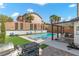 Inviting backyard oasis with a sparkling pool, spa, and covered patio at 5310 Esparon Ave, Las Vegas, NV 89141
