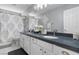 Bathroom with double vanity, gray countertops, and white cabinets at 5310 Esparon Ave, Las Vegas, NV 89141